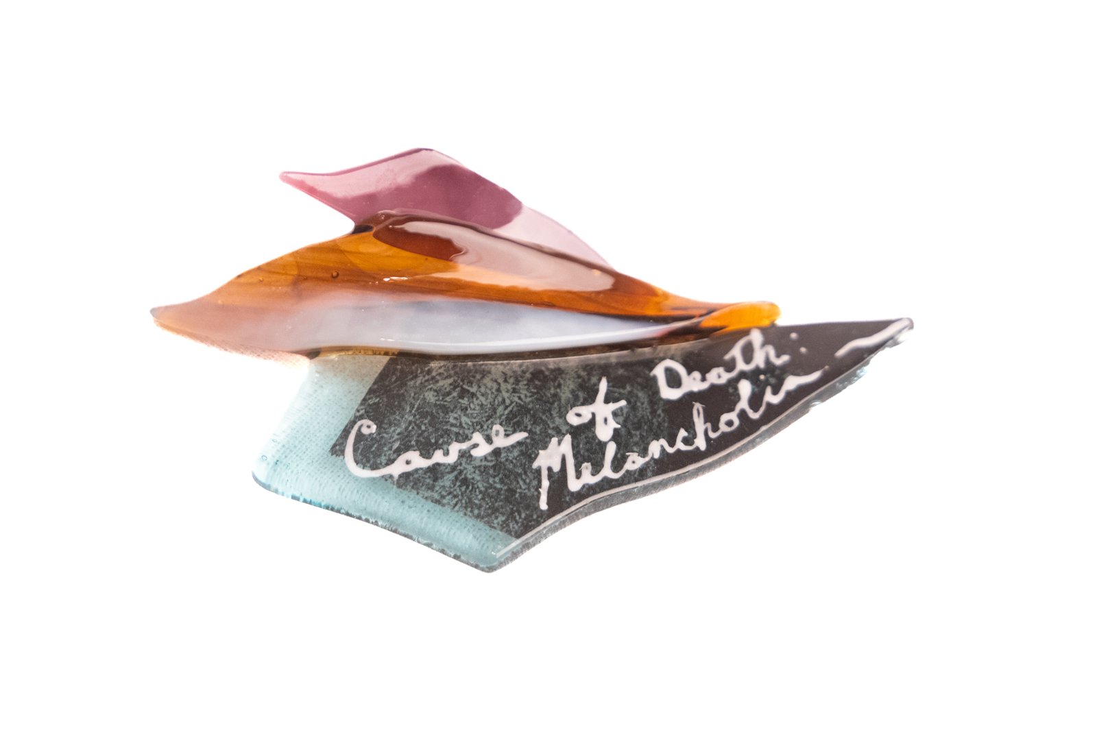 Fragments of colorful glass resting on a white background