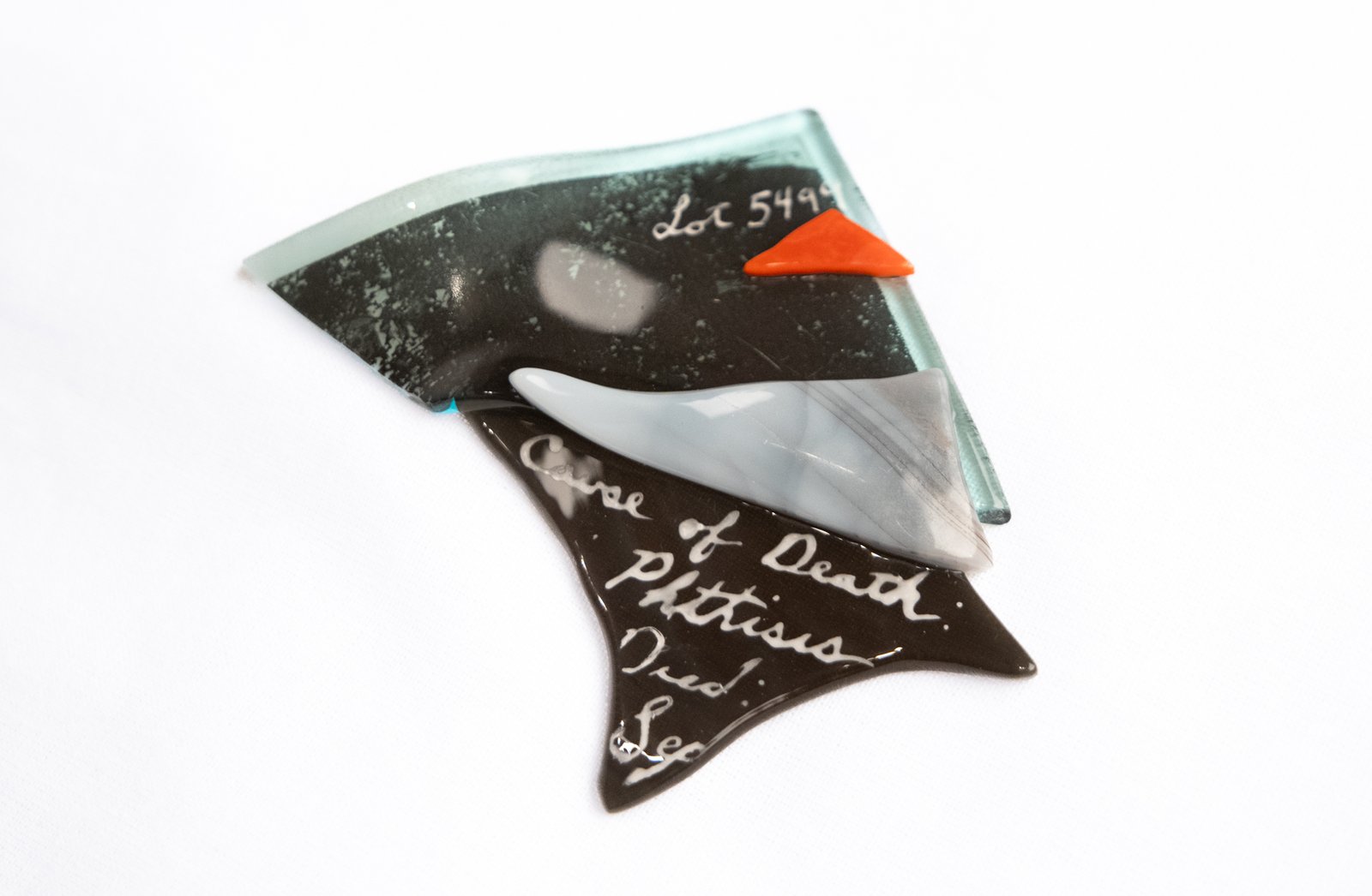 Fragments of colorful glass resting on a white background