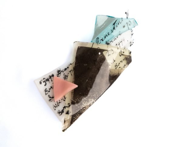 Fragments of colorful glass resting on a white background